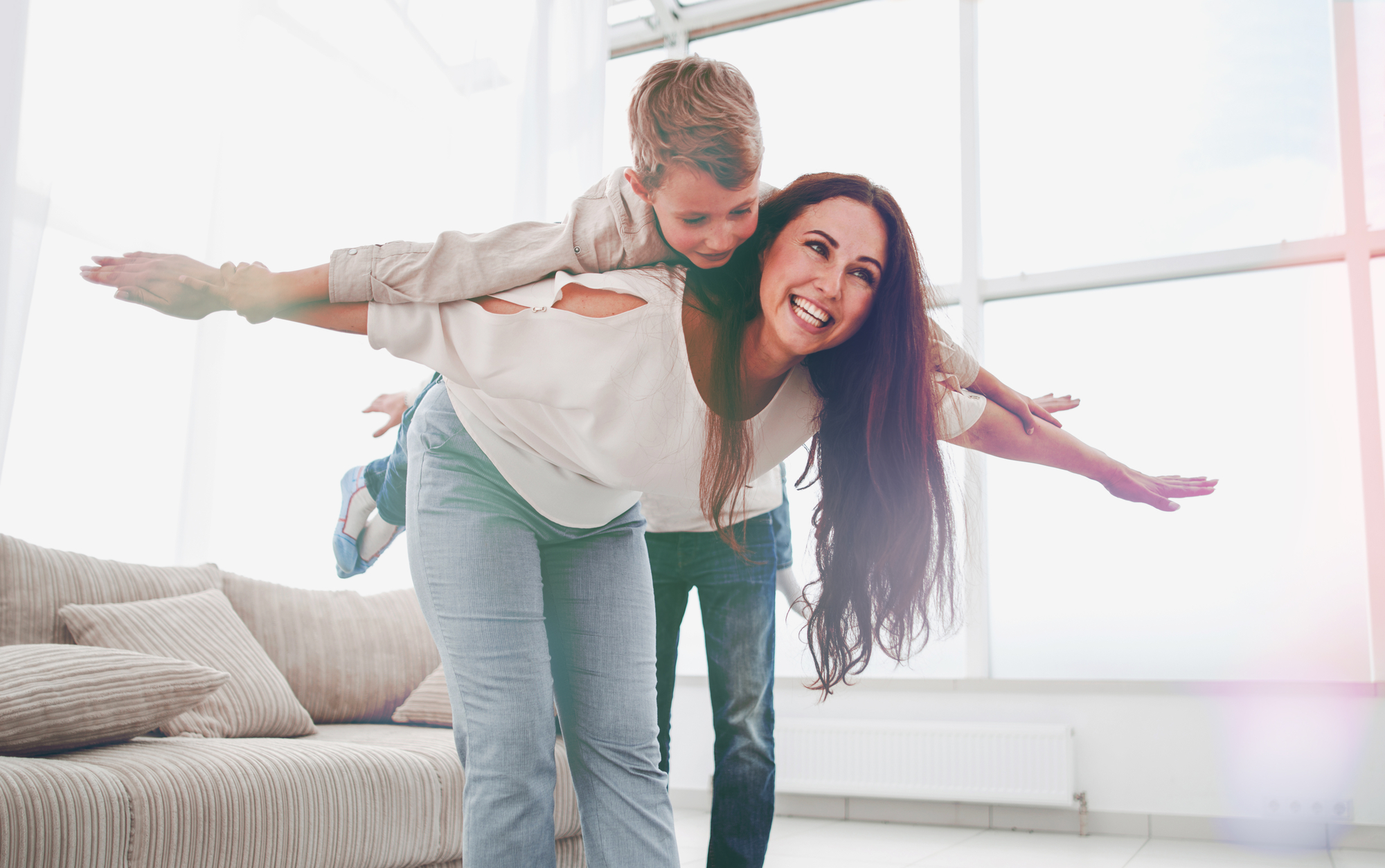 mother plays with her son in a spacious living room